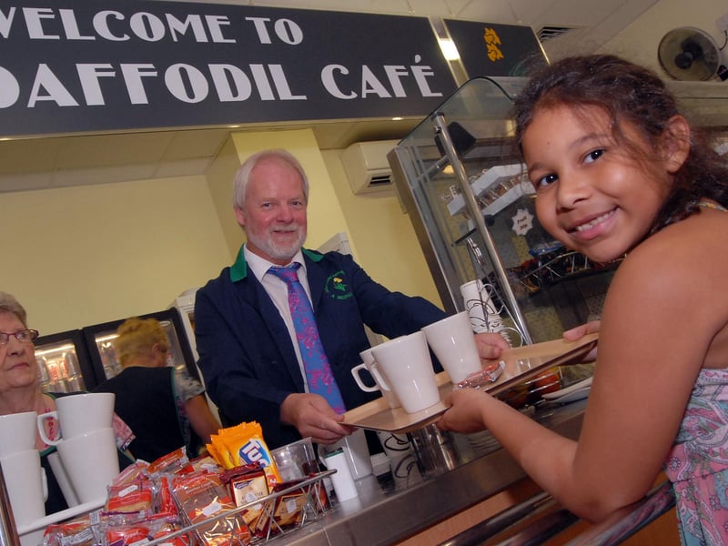 Nottinghamshire County Council chief executive Mick Burrows serves up tea to Daffodil Café customer Denisha Palin during a stint of volunteering at King's Mill Hospital in 2011.