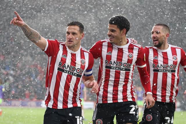 Billy Sharp celebrates with Morgan Gibbs-White of Sheffield United and Conor Hourihane (right) during the Sky Bet Championship match at Bramall Lane, Sheffield, against Bristol City: Alistair Langham / Sportimage