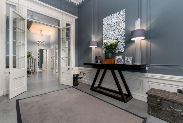 The entrance to the property boasts a spacious vestibule, which leads to a Caithness flagstone floored hallway with sweeping staircase