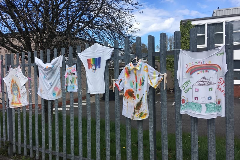 Before being sent home for lockdown, children draped their school's fence with tshirts they designed.