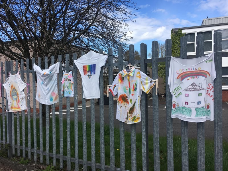 Before being sent home for lockdown, children draped their school's fence with tshirts they designed.