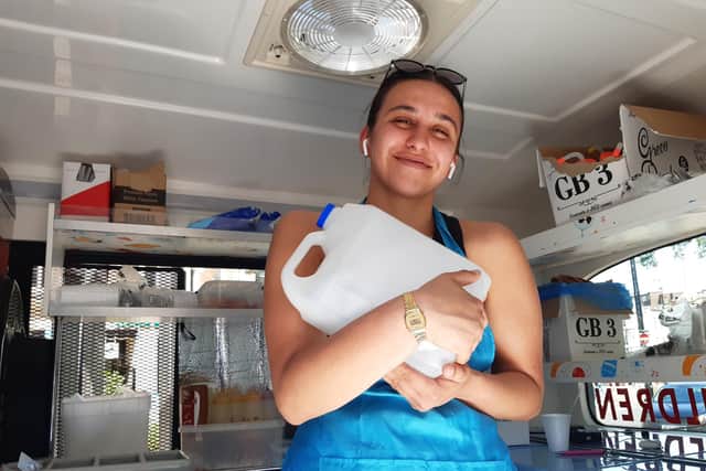 Ice cream seller Gabriella Earl clutches a frozen water bottle.