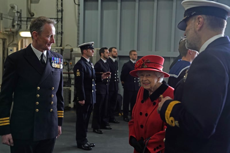 Queen Elizabeth II meeting personnel during a visit to HMS Queen Elizabeth at HM Naval Base, Portsmouth, ahead of the ship's maiden deployment. The visit comes as HMS Queen Elizabeth prepares to lead the UK Carrier Strike Group on a 28-week operational deployment travelling over 26,000 nautical miles from the Mediterranean to the Philippine Sea. Picture date: Saturday May 22, 2021. PA Photo. See PA story ROYAL Carrier. Photo credit should read: Steve Parsons/PA Wire