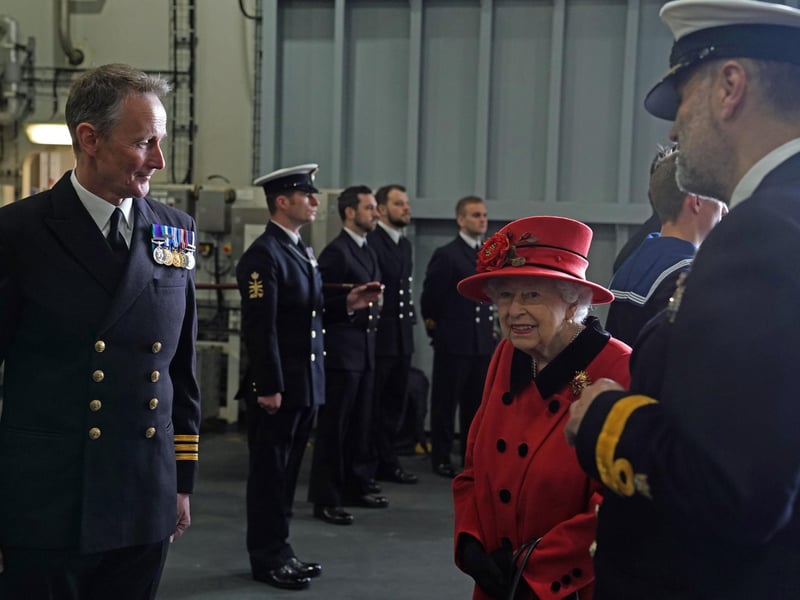 Queen Elizabeth II meeting personnel during a visit to HMS Queen Elizabeth at HM Naval Base, Portsmouth, ahead of the ship's maiden deployment. The visit comes as HMS Queen Elizabeth prepares to lead the UK Carrier Strike Group on a 28-week operational deployment travelling over 26,000 nautical miles from the Mediterranean to the Philippine Sea. Picture date: Saturday May 22, 2021. PA Photo. See PA story ROYAL Carrier. Photo credit should read: Steve Parsons/PA Wire
