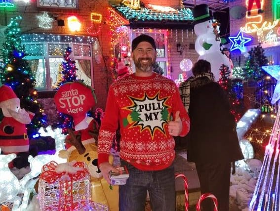 Richard Layne in front of the amazing Christmas lights display on Lyons Street in Pitsmoor, Sheffield, which he helped create to raise money for The Sick Children's Trust