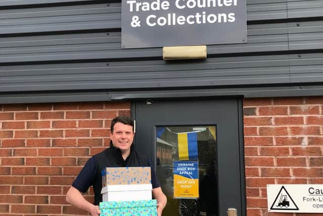 Sales Director at Pennine Lubricants, John Grierson, with some of the shoe box donations they have so far received.