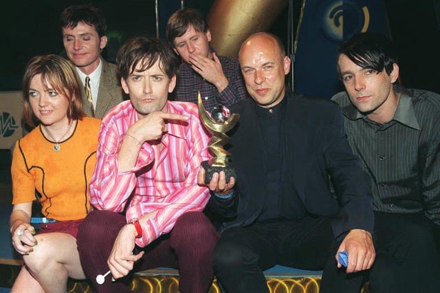 Pulp frontman Jarvis Cocker points at the 1996 Mercury Music Prize, awarded for their album 'Different Class' - the band are pictured with record producer Brian Eno who holds the trophy.