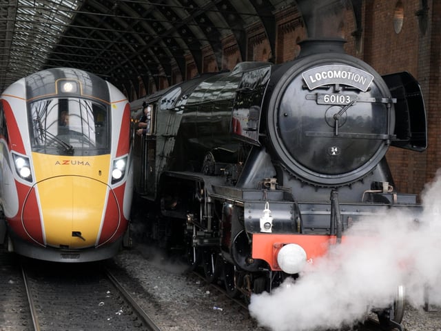 The legendary Flying Scotsman passes a waiting LNER train at Darlington Station.