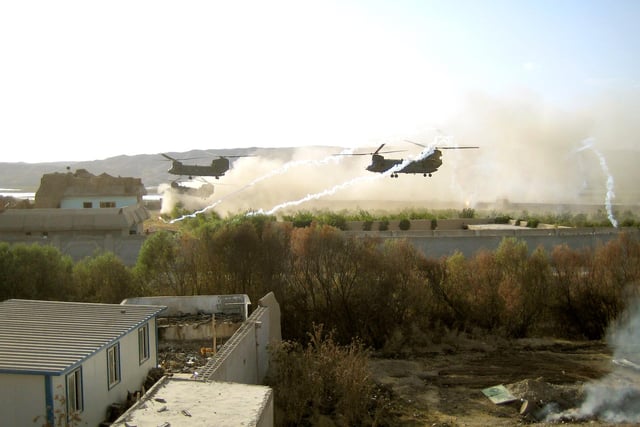 Chinooks landing at Sangin District Centre, Afghanistan. Protected by a fire plan own defence systems Apache Harrier and 105 mm guns firing from FOB Robinson