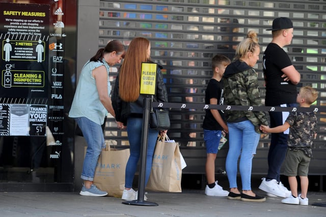 Shoppers queuing to get into JD Sports in Commercial Road, Portsmouth. Picture: Sarah Standing (150620-4162)