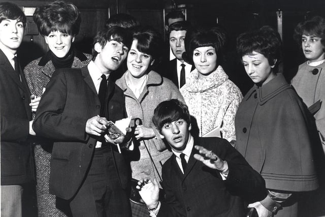 Paul McCartney, George Harrison and Ringo Starr and fans at the Beatles City hall concert on November 2 1963