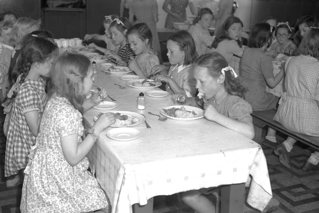 Children tuck in to a tasty meal at Middleton Camp. Can you remember what the food was like?