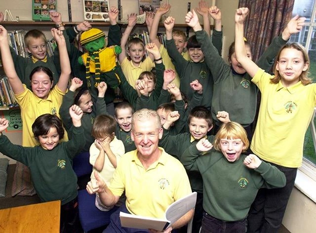 Head teacher Joe Dunn of the Southey Green Junior School with some of the pupils celebrating their OFSTED report on November 15, 2000