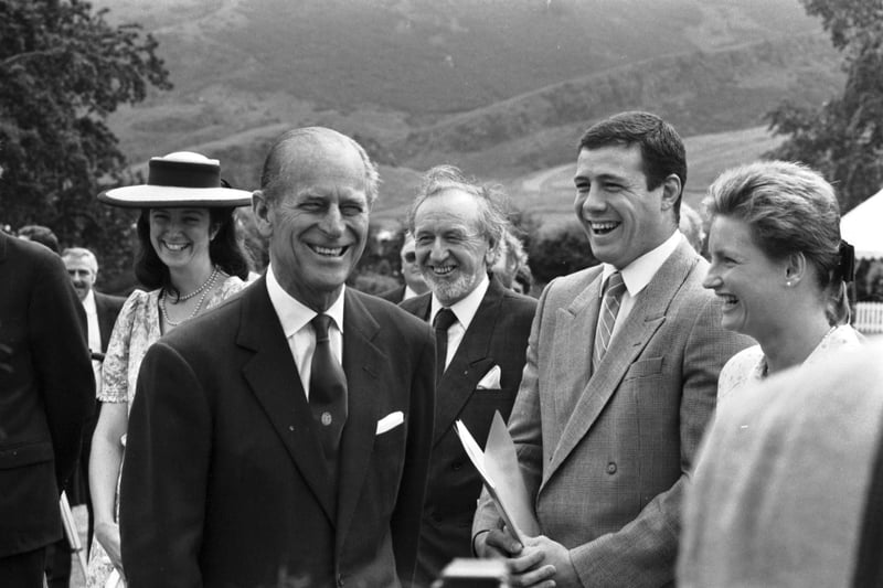 Prince Philip Duke of Edinburgh chats to Scottish international rugby player Scott Hastings and his (then) fiancee, biathlete Jenny Ovens, at the Palace of Holyroodhouse in Edinburgh (Holyrood Palace) when he presents the Duke of Edinburgh Gold Awards in July 1990.