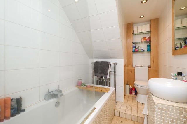 The modern family bathroom on the ground floor is fully tiled and is a good use of space.