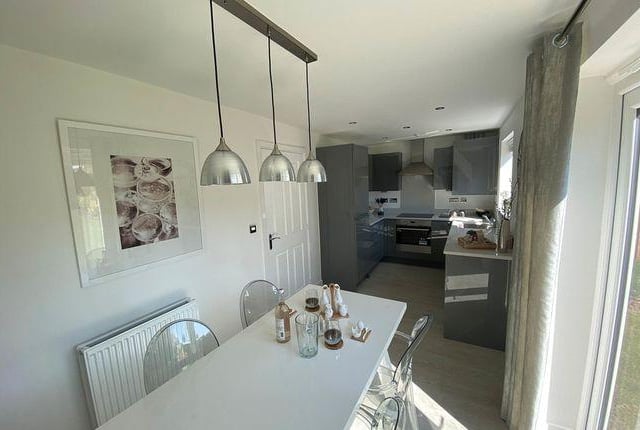 This new build house has an open plan kitchen/diner and garage.