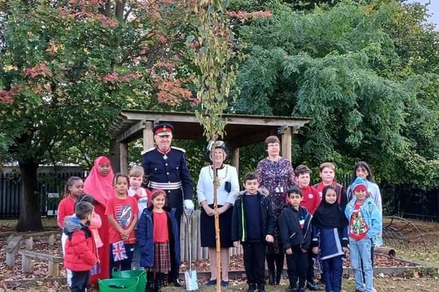 Pupils and headteacher Cath Whittingham are joined by Lord-Lieutenant of South Yorkshire Andrew Coombe and Lord Mayor of Sheffield Coun Gail Smith to plant a Queen's green canopy tree at Acres Hill Community Primary School.