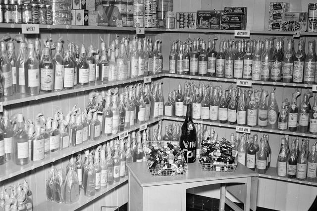 A Christmas display of bottle of port, sherry and jars of jam in an Edinburgh store in 1958.