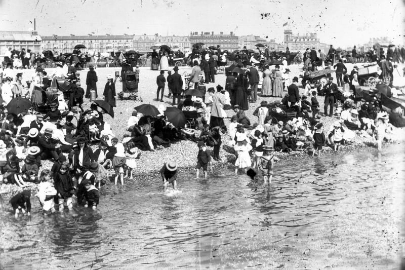 This photo from circa 1895 shows a stony and crowded beach at Southsea, a few children are paddling. Photo by F J Mortimer/Hulton Archive/Getty Images