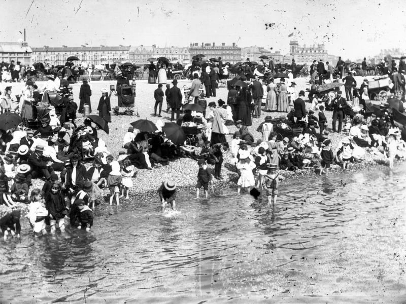 This photo from circa 1895 shows a stony and crowded beach at Southsea, a few children are paddling. Photo by F J Mortimer/Hulton Archive/Getty Images