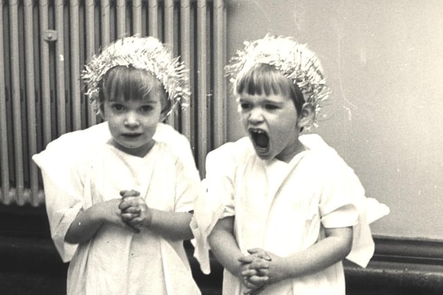 Twins Helena and Jayne Furniss aged 3 practise a little singing,,before the St Gabriel's playgroup Nativity play, Dobbin Hill, Sheffield December 16,  1980