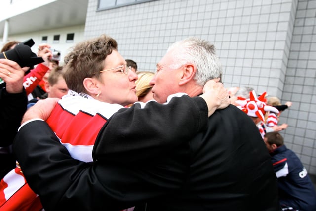 An enthusiastic fan greets John Ryan with a kiss ahead of the parade
