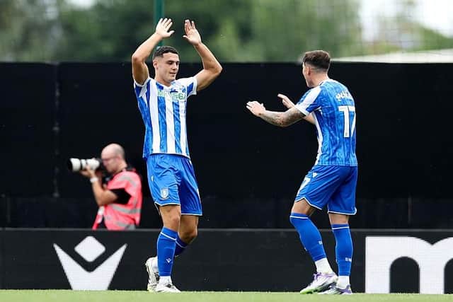 Bailey Cadamarteri (left) celebrates his equaliser at Wrexham with team-mate Charlie McNeill (Image: Jess Hornby/Getty Images)