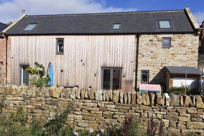 The property features original stonework and Siberian larch cladding to the rear.