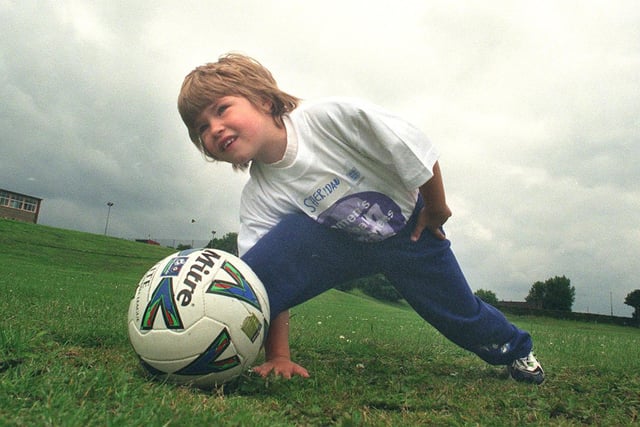 Little ladies with their eyes on the ball at Rainbow Forge school, Sheffield for the Womens football awareness week pic shows Sheridan Crouch doing some unacustomed stretcing exercises in 1999