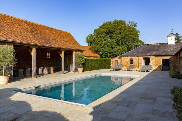 The Hampshire country house is a byword for style and luxury - as you can see from this outdoor swimming pool . It is located in a superb courtyard setting next to a covered dining area or party barn. The pool has a retractable cover too.