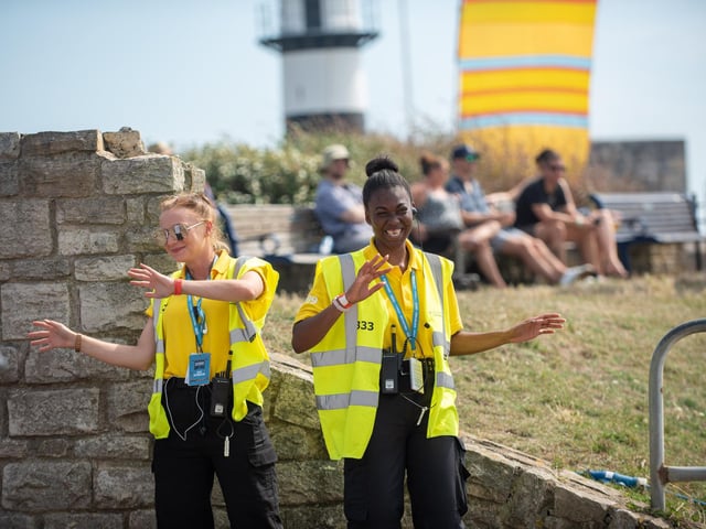 Security guards dancing to Great Scott 80s on the Seaside Stage. Picture: (250819-016)