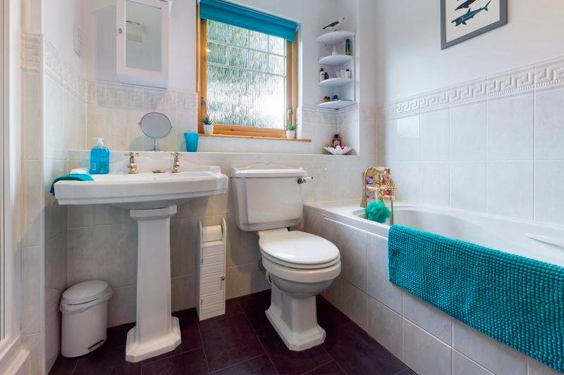 The large family bathroom has a bath and separate shower cubicle.