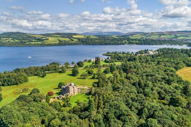 Aerial view of castle and grounds across to Loch Lomond.