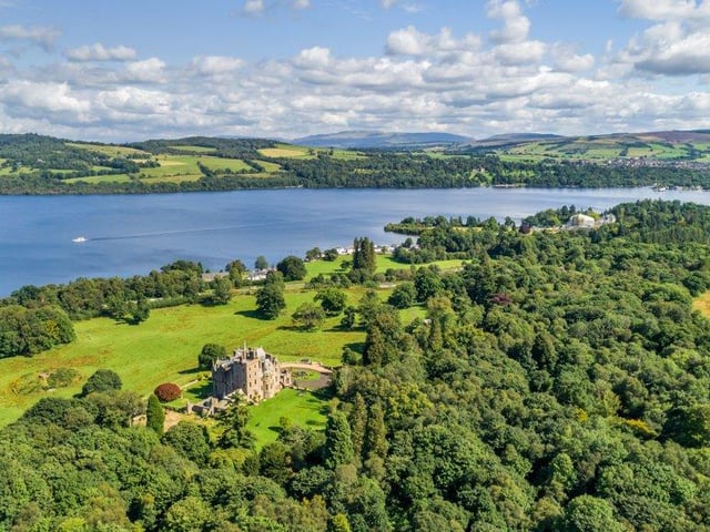 Aerial view of castle and grounds across to Loch Lomond.