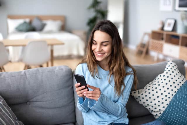 A first time buyer starts house hunting on her mobile