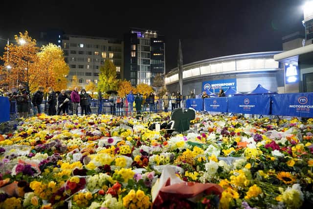 Fans look at floral tributes outside the Motorpoint Arena, Nottingham, ahead of a memorial for Nottingham Panthers' ice hockey player Adam Johnson. Adam Johnson died after sustaining an injury during a Challenge Cup match with Sheffield Steelers last Saturday. (Picture: Zac Goodwin/PA Wire)