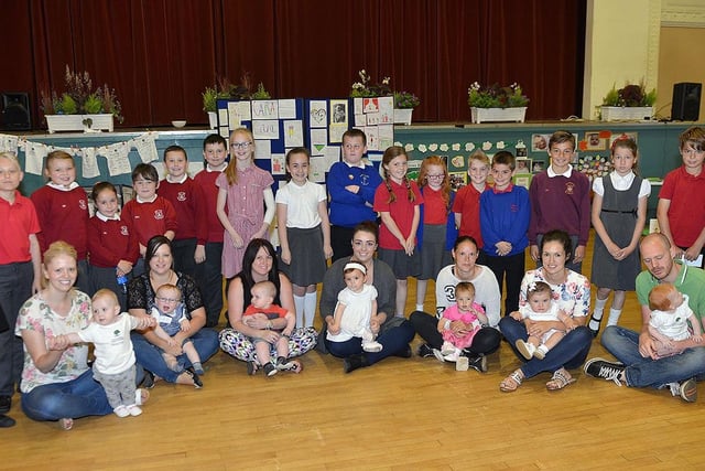 Parents and children pose for a historic picture with a selection of pupils from the different primary schools who attended the Baby Celebration event held in the Borough Hall.
