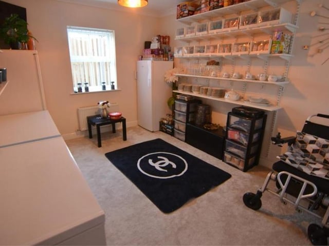 An additional reception room has the potential to be used as a sitting room, dining room, study or even a fifth bedroom. It has a carpeted floor, while the window looks out to the front of the property.