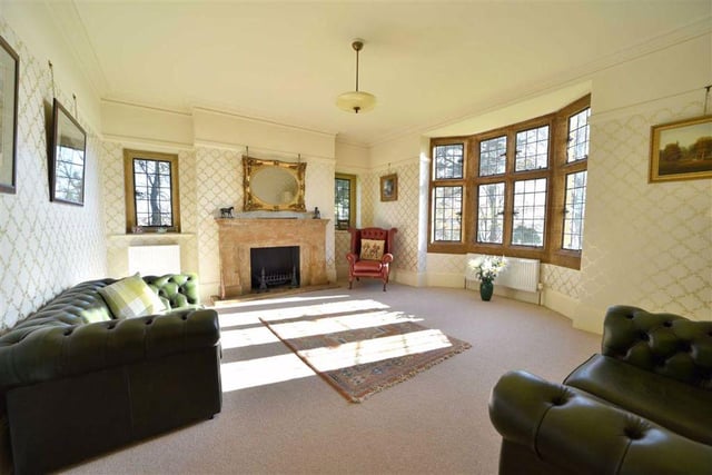 Bright and spacious, the drawing room boasts an impressive light stone mullion bay window which overlooks the rear garden and an ornate open hearth fireplace with a carved ironstone mantle.