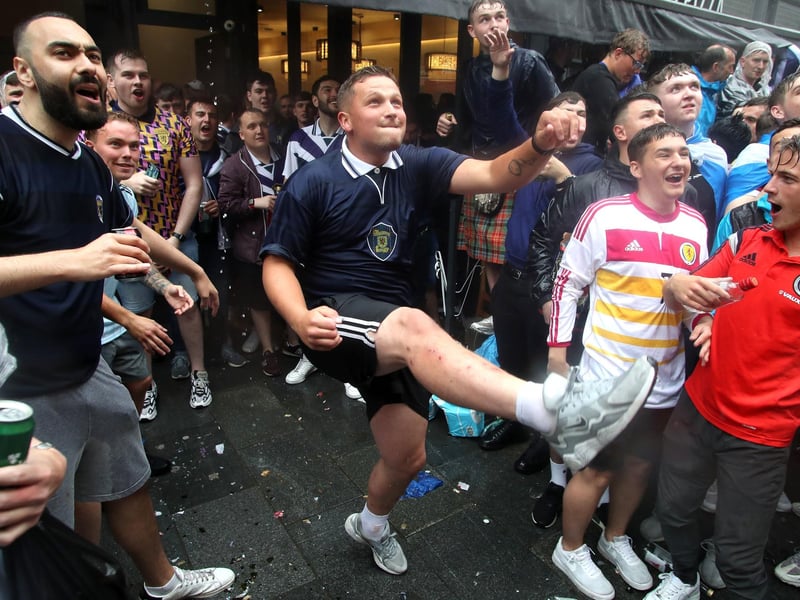 A fan in motion after kicking a football into the crowds (Photo: Kieran Cleeves/PA Wire).
