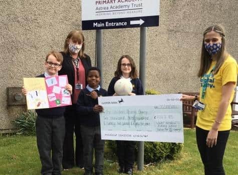 Lower Meadow Academy handing a cheque to a Sheffield Children's Hospital representative.