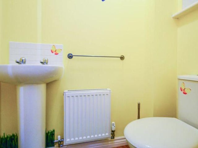 Although the main bathroom is on the first floor, this downstairs toilet is handy. It features a low-flush WC and wash hand basin.