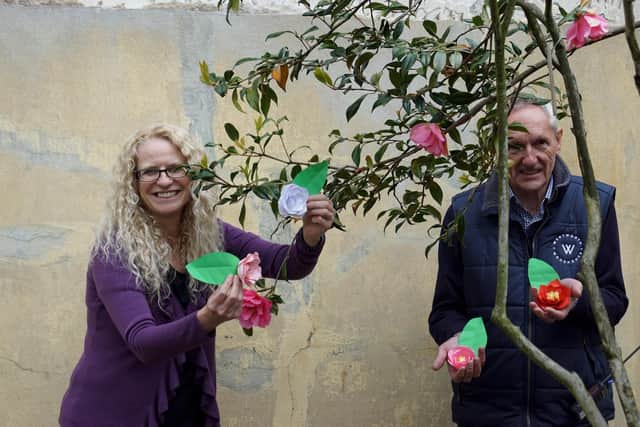Activity Planning Consultant Dr Suzanne Carter, pictured with volunteer Jonathan Robinson with handmade blooms at the Camellia House