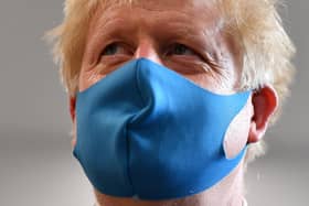 Britain's Prime Minister Boris Johnson, wearing a face mask (Photo by Ben Stansall-WPA Pool/Getty Images)