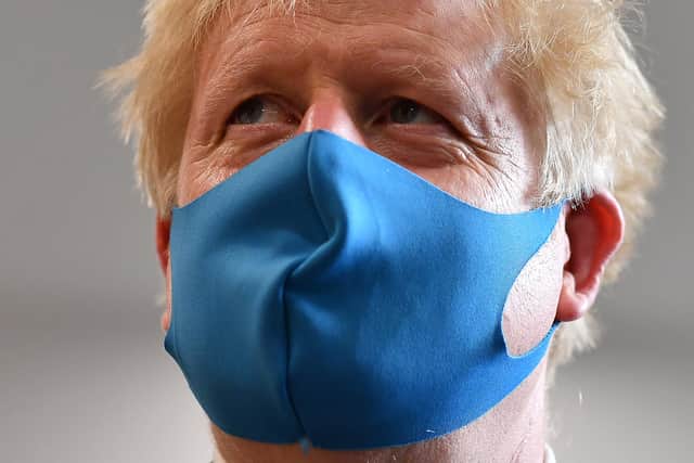 Britain's Prime Minister Boris Johnson, wearing a face mask (Photo by Ben Stansall-WPA Pool/Getty Images)