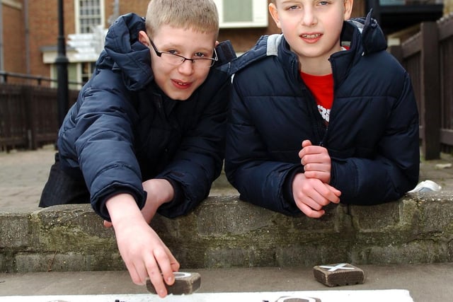 Brothers Daniel (left) and Ethan Butler playing noughts and crosses at the Historic Quay in 2013.