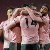 Sheffield United's Oliver Burke, 14, is congratulated by teammates after scoring the winner against Manchester United (AP Photo/Tim Keeton,Pool)