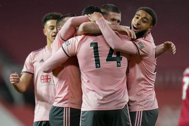 Sheffield United's Oliver Burke, 14, is congratulated by teammates after scoring the winner against Manchester United (AP Photo/Tim Keeton,Pool)