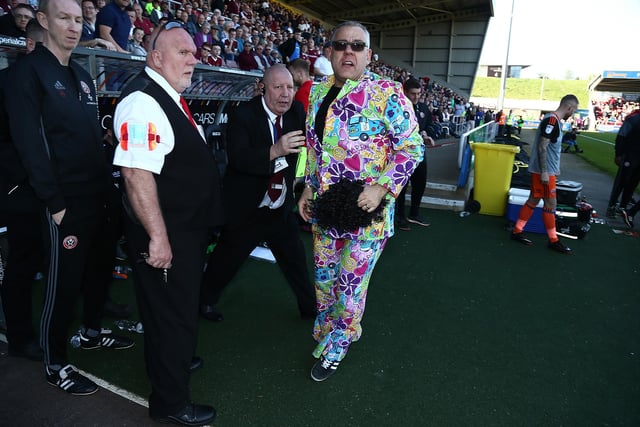 A Sheffield United fan is escorted from the dug out as fans celebtrate promotion to the championship during the Sky Bet League One match between Northampton Town and Sheffield United at Sixfields on April 8, 2017 in Northampton, England.  (Photo by Pete Norton/Getty Images)