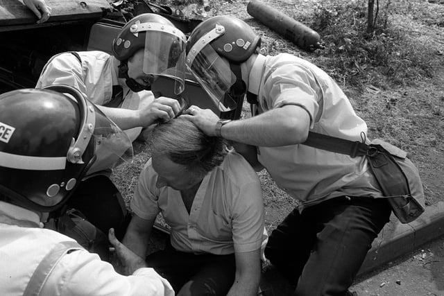 NUM leader Arthur Scargill receives treatment from ambulancemen after sustaining injuries at Orgreave
